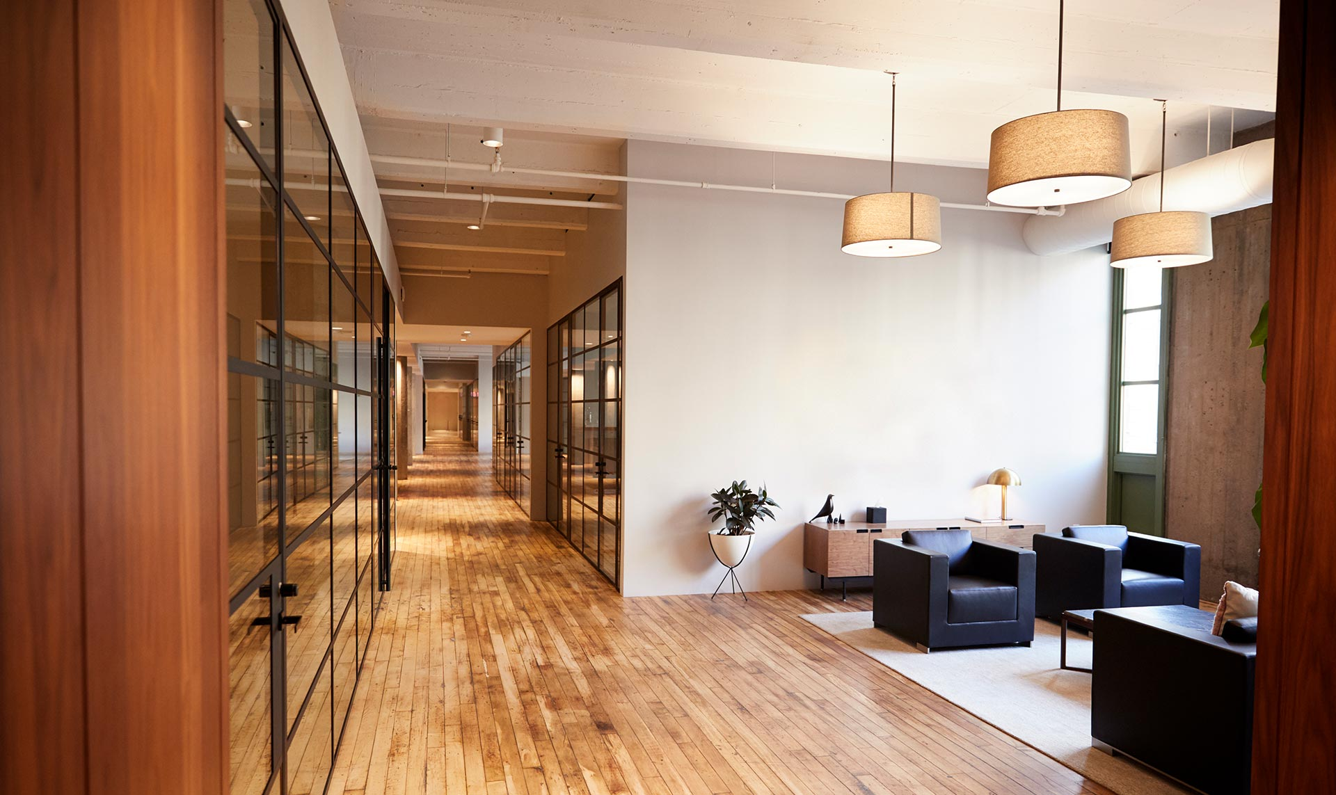 Modern office interior with glass walls and wooden floors